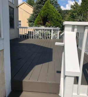 A deck featuring white railings, providing a clean and modern aesthetic to the outdoor space.
